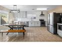 Modern kitchen with white cabinets, stainless steel appliances, and a breakfast nook at 18611 N 22Nd St # 2, Phoenix, AZ 85024