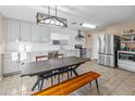 Modern kitchen with white cabinets, stainless steel appliances, and a breakfast nook at 18611 N 22Nd St # 2, Phoenix, AZ 85024