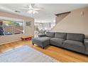 Living room with gray sectional sofa, hardwood floors, and ceiling fan at 18611 N 22Nd St # 2, Phoenix, AZ 85024