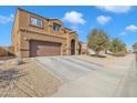 Two-story house with brown exterior, attached garage, and driveway at 1923 N Cocoa Ct, Casa Grande, AZ 85122