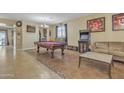 Game room features a pool table, arcade game, and comfortable seating at 1923 N Cocoa Ct, Casa Grande, AZ 85122