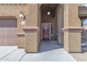House entrance with arched entryway, double doors, and exterior lighting at 1923 N Cocoa Ct, Casa Grande, AZ 85122