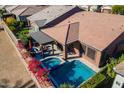 An aerial view of backyard oasis with pool, spa, and patio with lush landscaping at 267 E Santa Lucia Ln, Queen Creek, AZ 85140