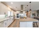 Modern kitchen featuring white cabinets, stainless steel appliances, and a large island with bar seating at 267 E Santa Lucia Ln, Queen Creek, AZ 85140