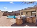 Backyard oasis with a pool and built-in grilling station at 2832 E Flower St, Gilbert, AZ 85298