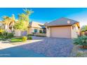 Three car garage with paver driveway and landscaping at 2835 E Athena Ct, Gilbert, AZ 85297