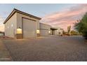 Three car garage with stone accents and upgraded lighting at 29616 N 140Th St, Scottsdale, AZ 85262