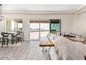 Spacious living area with large windows and access to backyard at 30039 N 209Th Ave, Wittmann, AZ 85361