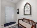 Inviting entryway with a wooden bench, mirror, and decorative wall art at 41844 W Rosa Dr, Maricopa, AZ 85138