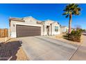 House exterior featuring a two-car garage and desert landscaping at 41844 W Rosa Dr, Maricopa, AZ 85138