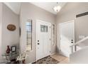 Bright entryway with white door, tiled floor, and a small table at 5416 E Glencove St, Mesa, AZ 85205