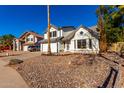 Two-story house with a white garage door and rock landscaping, next to other homes at 5416 E Glencove St, Mesa, AZ 85205