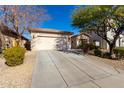 Single story home with a two-car garage and a long driveway at 5512 W Cavedale Dr, Phoenix, AZ 85083