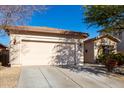 Single story home with a two-car garage and desert landscaping at 5512 W Cavedale Dr, Phoenix, AZ 85083