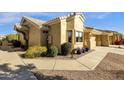 Tan house exterior with landscaped walkway and potted plants at 5830 E Mckellips Rd # 66, Mesa, AZ 85215