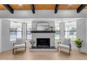 Living area featuring a contemporary fireplace and large windows at 6613 W Sweetwater Ave, Glendale, AZ 85304