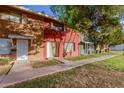 Red and green brick duplex with a walkway and lawn at 6654 N 43Rd Ave, Glendale, AZ 85301