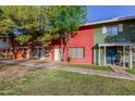 Row of townhouses with red and green painted brick exteriors at 6654 N 43Rd Ave, Glendale, AZ 85301