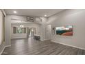 Spacious living room with gray walls and wood-look floors at 6703 W Linda Ln, Chandler, AZ 85226
