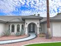 Front entry with walkway and arched doorway at 10241 N Nicklaus Dr, Fountain Hills, AZ 85268