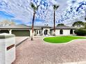 Front view of single story home with landscaped lawn at 10241 N Nicklaus Dr, Fountain Hills, AZ 85268