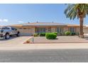 Ranch-style home with solar panels and landscaped yard at 11030 W Pleasant Valley W Rd, Sun City, AZ 85351