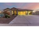 Single-story house with a three-car garage, and well-manicured landscaping at 11105 E Quintana Ave, Mesa, AZ 85212