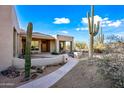 Lovely exterior featuring a walkway, cacti, and desert landscaping at 148 N La Barge Rd, Apache Junction, AZ 85119