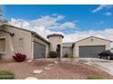 Two-story house with three-car garage and landscaped front yard at 14918 W Escondido Dr, Litchfield Park, AZ 85340
