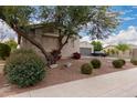 One-story house with a two-car garage and nicely landscaped yard at 14918 W Escondido Dr, Litchfield Park, AZ 85340