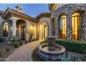 Elegant entryway with fountain and arched doorways at 15402 E Crested Butte Trl, Fountain Hills, AZ 85268