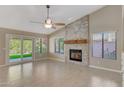 Living room features a stone fireplace and tile flooring at 1656 E Montoya Ln, Phoenix, AZ 85024