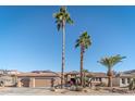 Single-story home with three-car garage and desert landscaping at 18031 N Timber Ridge Dr, Surprise, AZ 85374