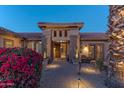 Elegant entryway with iron gate and landscaped courtyard at 18031 N Timber Ridge Dr, Surprise, AZ 85374