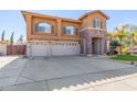 Two-story house with three-car garage and front yard at 2415 W Desperado Way, Phoenix, AZ 85085