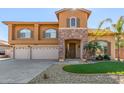 Two-story house with three-car garage and landscaped front yard at 2415 W Desperado Way, Phoenix, AZ 85085