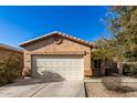 Tan one-story house with a two-car garage and small front yard at 28452 N Crimm Rd, San Tan Valley, AZ 85143