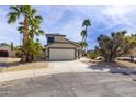 Inviting single-Gathering home with a two-car garage and desert landscaping featuring mature palm trees at 3024 E Siesta Ln, Phoenix, AZ 85050