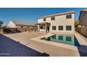 Relaxing backyard pool with patio and fire pit at 30313 W Mitchell Ave, Buckeye, AZ 85396
