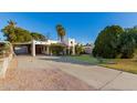 View of the house from the street, showing the carport and yard at 3126 E Monte Vista Rd, Phoenix, AZ 85008