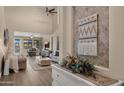 Inviting living room with high ceilings, stylish decor, and seamless flow to the dining area, ideal for modern living at 3462 E Riopelle Ave, Gilbert, AZ 85298