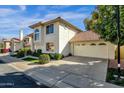 Two-story house with Spanish-style tile roof, attached garage, and mature landscaping at 3801 E Orchid Ln, Phoenix, AZ 85044