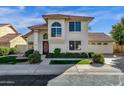 Two-story house with Spanish-style tile roof, attached garage, and manicured lawn at 3801 E Orchid Ln, Phoenix, AZ 85044