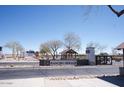 Rancho Mirage community entrance with signage, desert landscaping, and a clear blue sky at 38133 W Vera Cruz Dr, Maricopa, AZ 85138