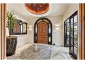 Grand entryway with arched wood door and tile flooring at 3817 N Jokake Dr, Scottsdale, AZ 85251