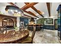 Spacious kitchen with dark cabinetry, large island, and exposed beams at 3817 N Jokake Dr, Scottsdale, AZ 85251