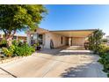 Mobile home with carport and well-maintained landscaping at 437 E Germann Rd # 24, San Tan Valley, AZ 85140