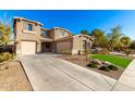 Two-story house with driveway, landscaping, and attached garage at 472 W Dragon Tree Ave, Queen Creek, AZ 85140