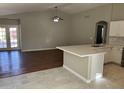 Open concept kitchen with island and adjacent living area at 4828 W Topeka Dr, Glendale, AZ 85308