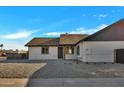 Updated home exterior with a fresh coat of paint and modern finishes at 5748 N 67Th Dr, Glendale, AZ 85303